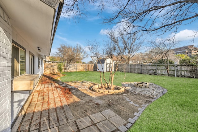 view of yard with an outdoor fire pit, an outdoor structure, a fenced backyard, and a shed