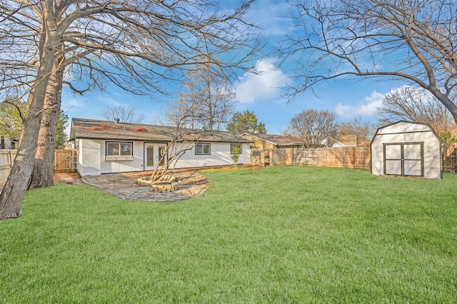 back of house with an outbuilding, a fenced backyard, a lawn, and a storage unit