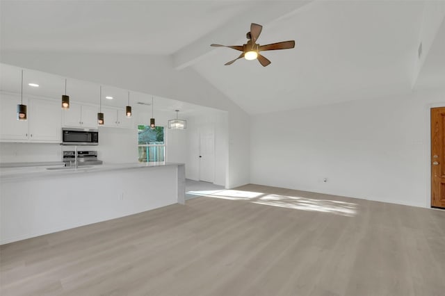 unfurnished living room with light wood-type flooring, vaulted ceiling with beams, a sink, and ceiling fan