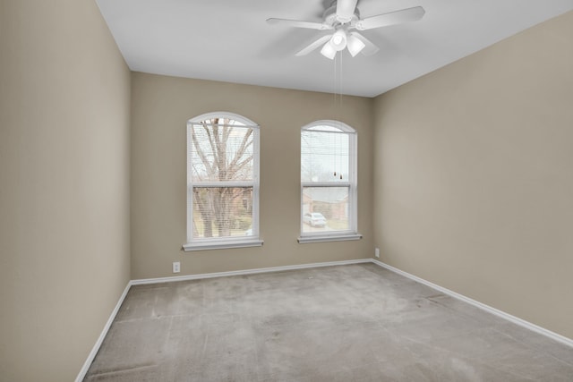 empty room featuring carpet flooring, baseboards, and ceiling fan