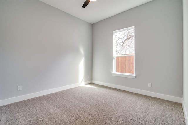 unfurnished room featuring carpet, a ceiling fan, and baseboards