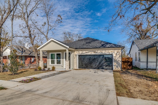 view of front of property with driveway, a shingled roof, an attached garage, and fence