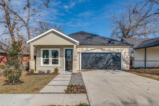 view of front of home with a shingled roof, concrete driveway, stone siding, and an attached garage