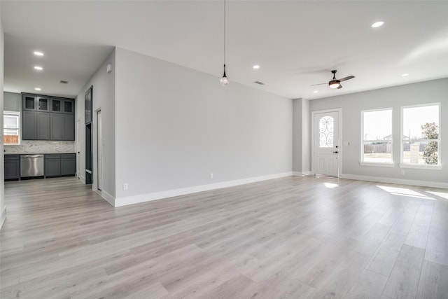 unfurnished living room with baseboards, recessed lighting, a ceiling fan, and light wood-style floors