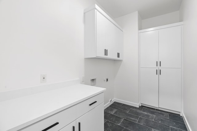 laundry room with baseboards, cabinet space, and hookup for an electric dryer