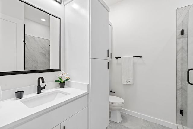 bathroom featuring baseboards, toilet, vanity, and a marble finish shower