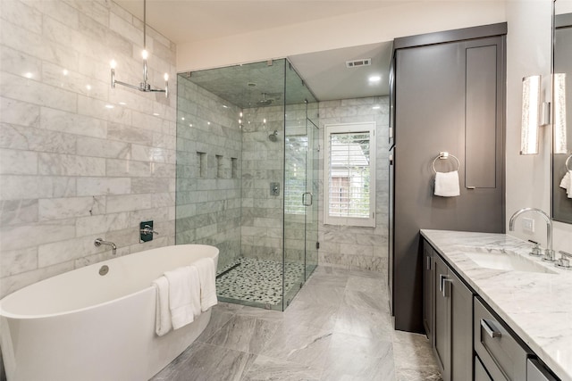 bathroom with vanity, visible vents, tile walls, a soaking tub, and a stall shower