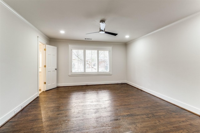 spare room featuring visible vents, baseboards, dark wood finished floors, and crown molding