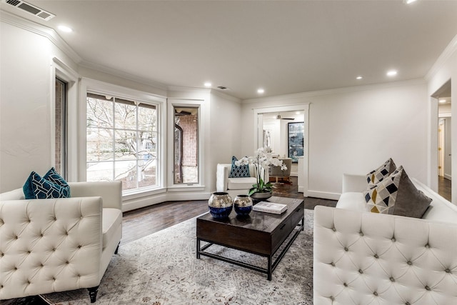 living area featuring recessed lighting, visible vents, crown molding, and wood finished floors