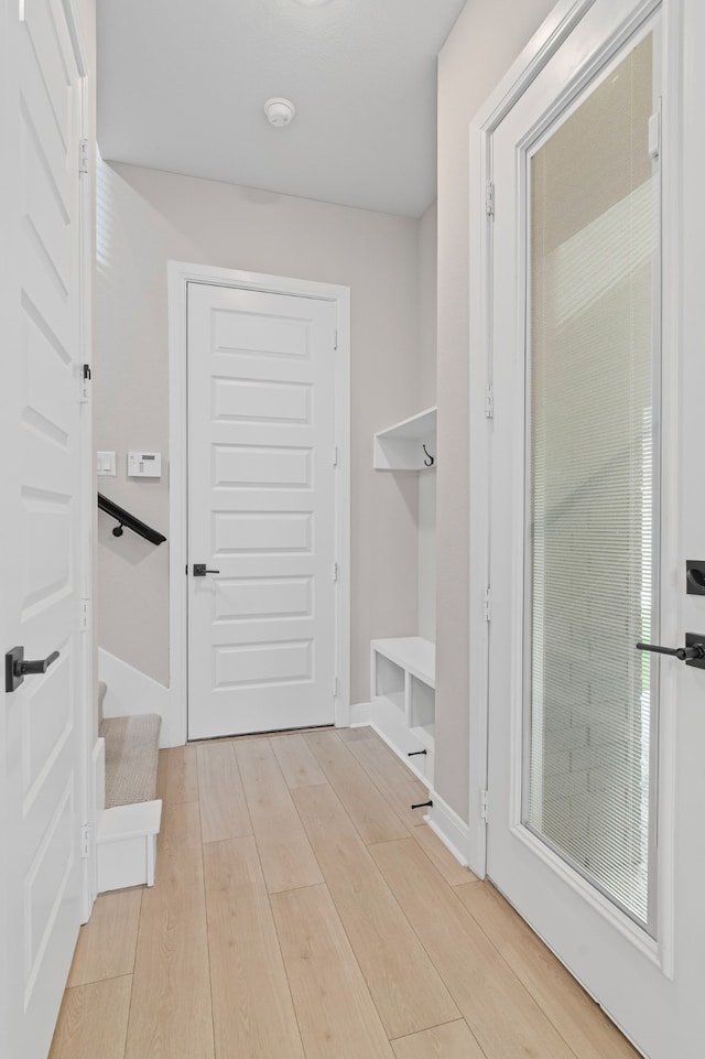 mudroom featuring light wood-style floors and baseboards