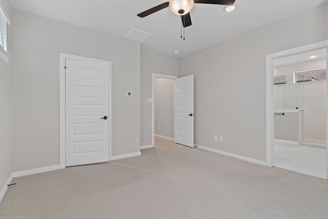 unfurnished bedroom featuring light carpet, visible vents, baseboards, and ceiling fan