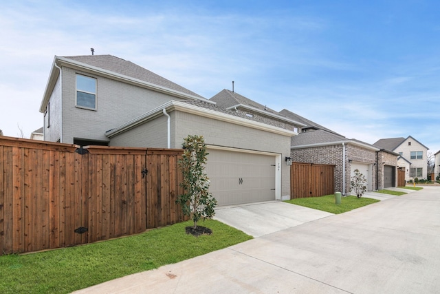 view of home's exterior featuring brick siding, roof with shingles, concrete driveway, fence, and a garage