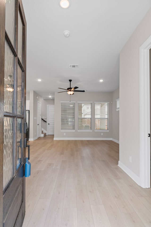 unfurnished living room with recessed lighting, a ceiling fan, visible vents, baseboards, and light wood finished floors