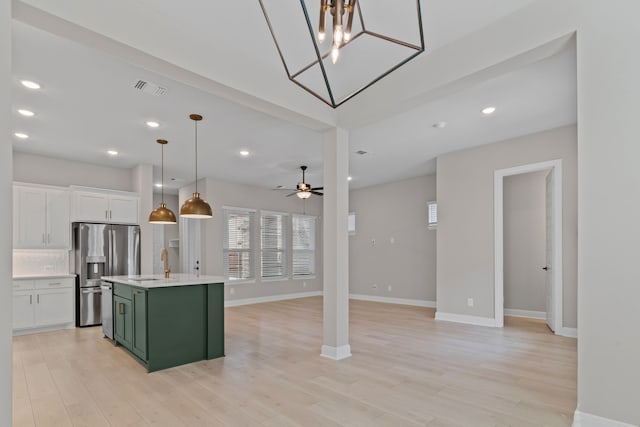 kitchen featuring stainless steel appliances, white cabinetry, visible vents, light countertops, and green cabinetry