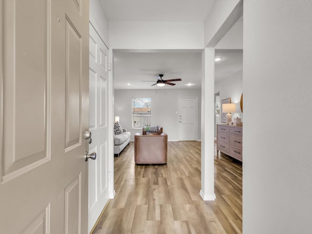 foyer entrance featuring ceiling fan and light wood-type flooring