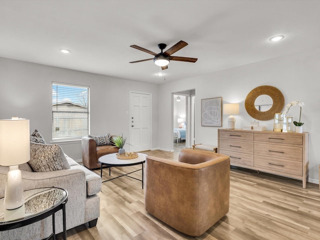 living area with light wood-style flooring, baseboards, ceiling fan, and recessed lighting