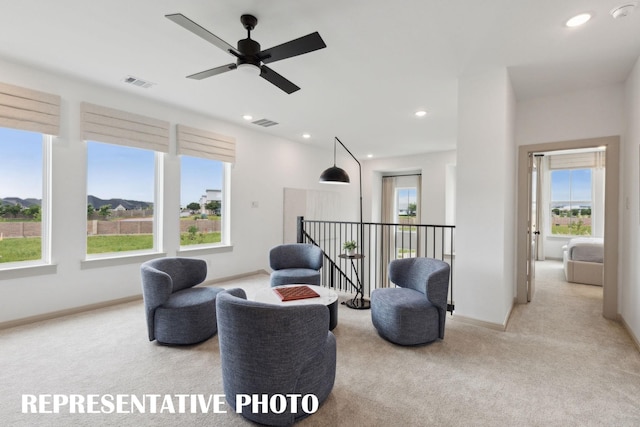 sitting room featuring light carpet, an upstairs landing, visible vents, and recessed lighting