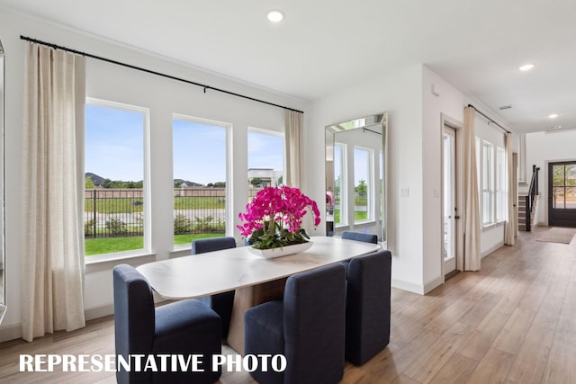 dining space featuring baseboards, light wood-style flooring, and recessed lighting