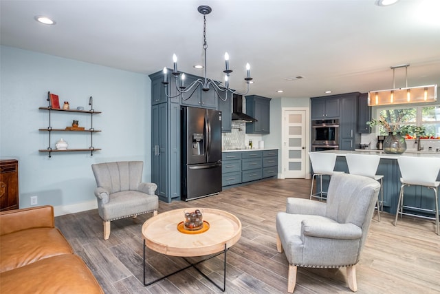 living area featuring light wood-style flooring, visible vents, baseboards, and recessed lighting