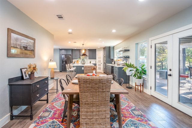 dining space with recessed lighting, visible vents, baseboards, french doors, and light wood-type flooring