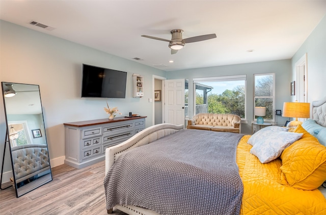 bedroom with light wood-type flooring, ceiling fan, visible vents, and baseboards