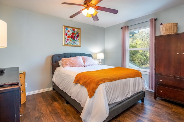 bedroom featuring dark wood-style floors, ceiling fan, and baseboards