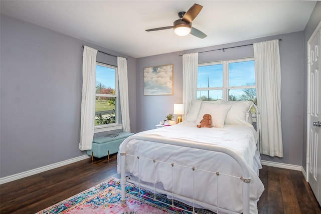 bedroom featuring a ceiling fan, dark wood-style flooring, and baseboards