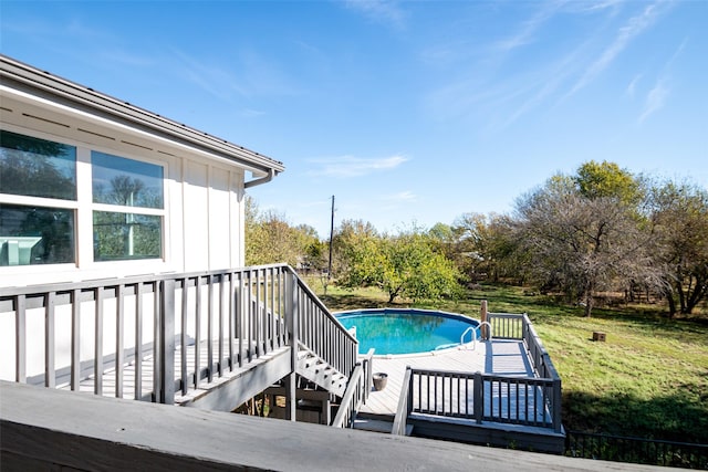 pool with a yard, stairway, and a wooden deck