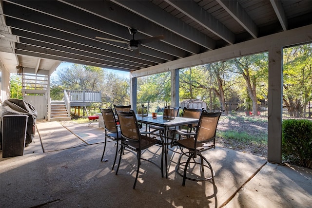 view of patio featuring a fenced backyard, stairway, a ceiling fan, and outdoor dining space