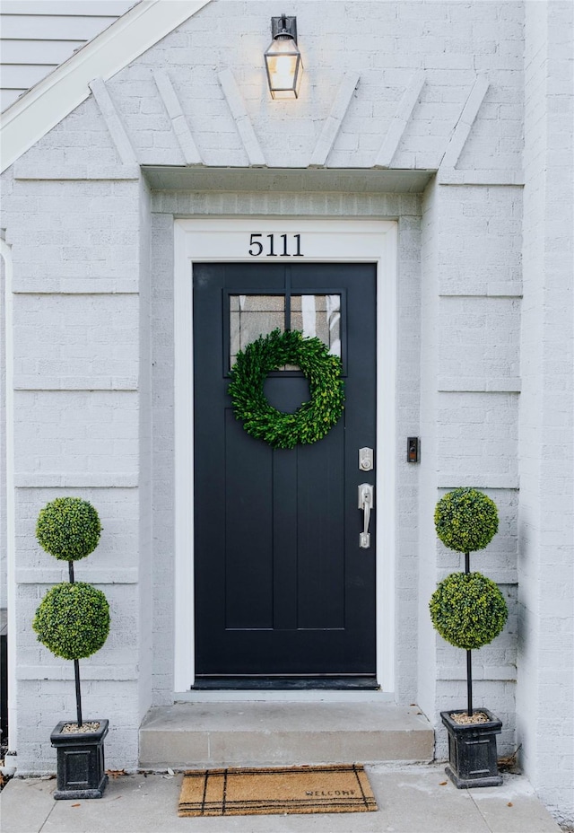 property entrance with brick siding