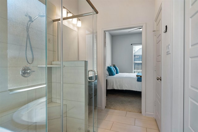 ensuite bathroom featuring tile patterned floors, a shower stall, and connected bathroom