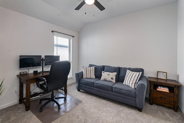 carpeted office space featuring a ceiling fan, lofted ceiling, and baseboards