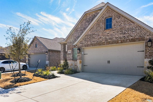 view of front of house with a garage, brick siding, and driveway