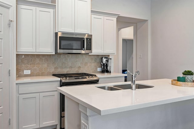 kitchen featuring stainless steel appliances, backsplash, a sink, and light countertops