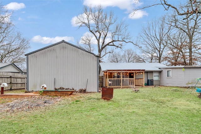 view of outdoor structure featuring central AC unit and fence