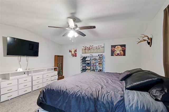 bedroom featuring lofted ceiling, carpet flooring, and a ceiling fan