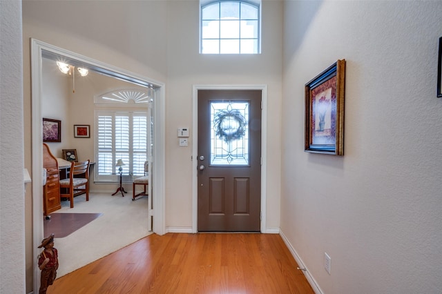 foyer entrance featuring light wood-style floors and baseboards