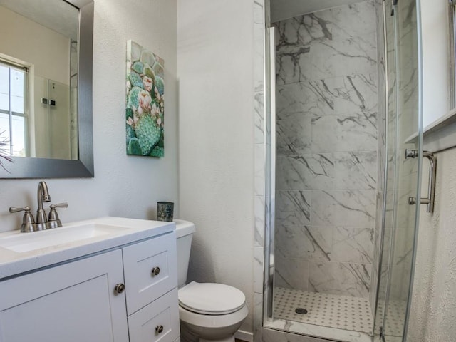 full bath featuring toilet, a marble finish shower, and vanity