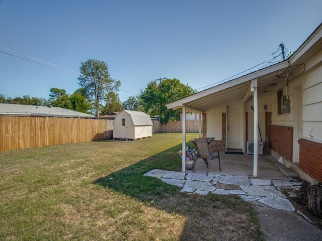 view of yard with an outbuilding, a fenced backyard, a patio, and a storage shed