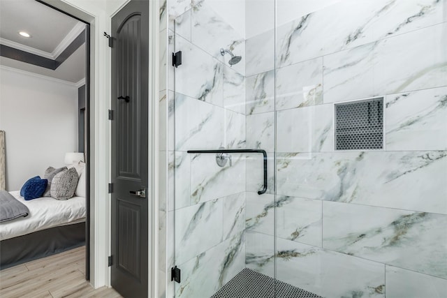 ensuite bathroom featuring wood finished floors, a stall shower, connected bathroom, and crown molding