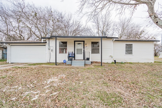 view of front of home with a garage, covered porch, and driveway