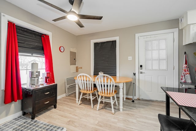 dining room featuring light wood-style floors, ceiling fan, and baseboards