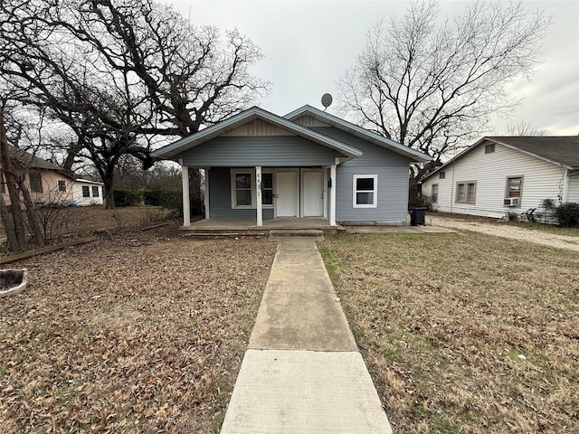 bungalow featuring a front yard and covered porch