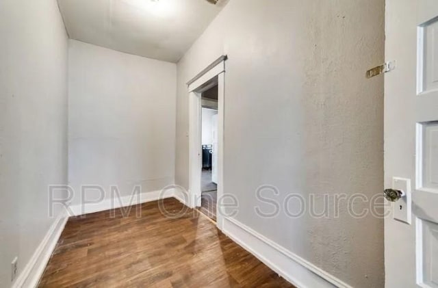 spare room featuring wood finished floors