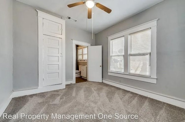 unfurnished bedroom featuring light carpet, connected bathroom, and visible vents