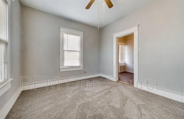 spare room featuring carpet and ceiling fan