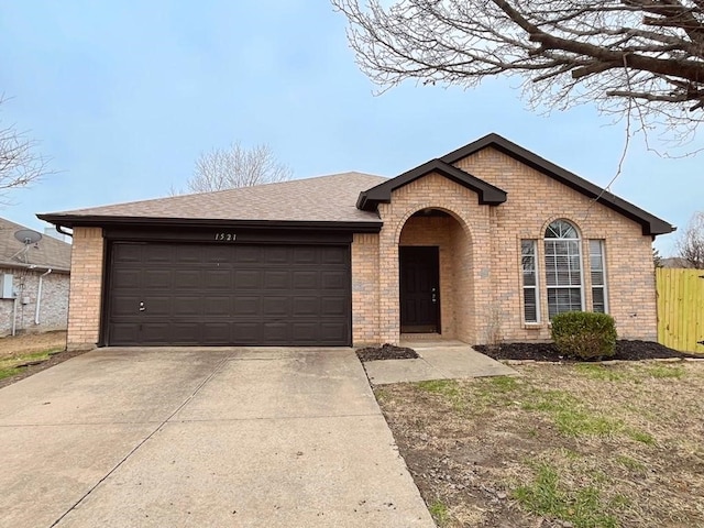 ranch-style house with concrete driveway, brick siding, roof with shingles, and an attached garage