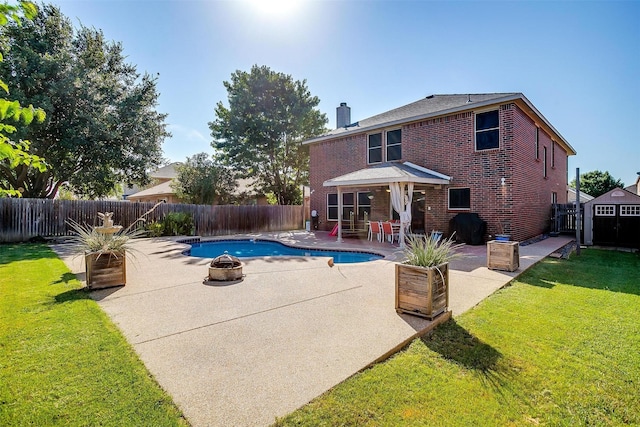 view of pool with a patio, a fenced in pool, an outdoor fire pit, a fenced backyard, and a lawn