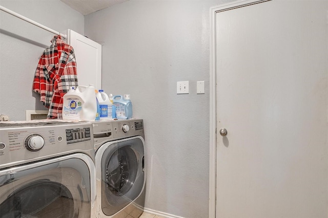 clothes washing area with washing machine and dryer and laundry area