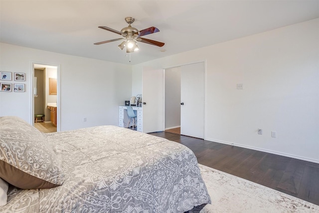 bedroom featuring ensuite bathroom, baseboards, wood finished floors, and a ceiling fan